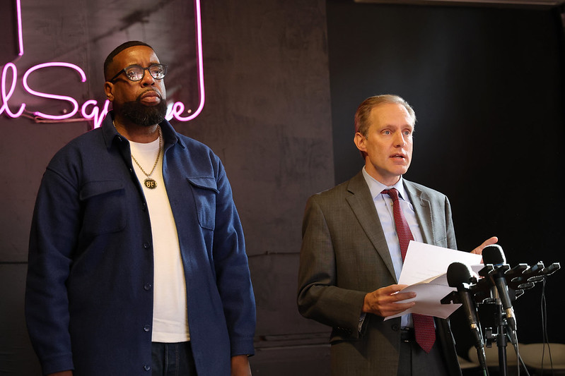 Brian Fullman and Secretary Simon at a press conference