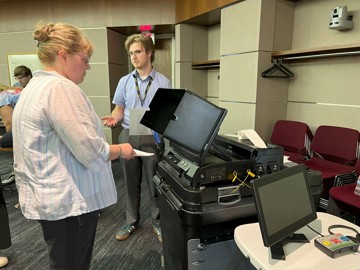 Election workers test a ballot tabulator
