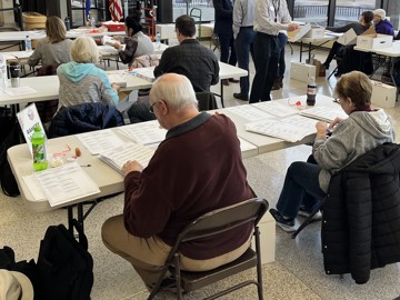 Election workers conduct a hand recount