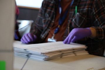 Election worker hand counts ballots